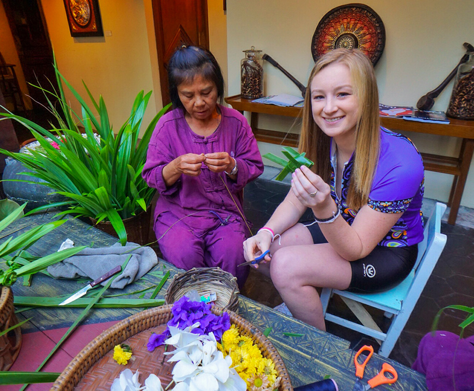 Backroads guest sitting with a local in Thailand