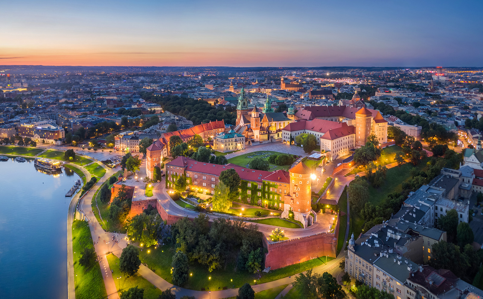 Aerial view of glowing European city at night.