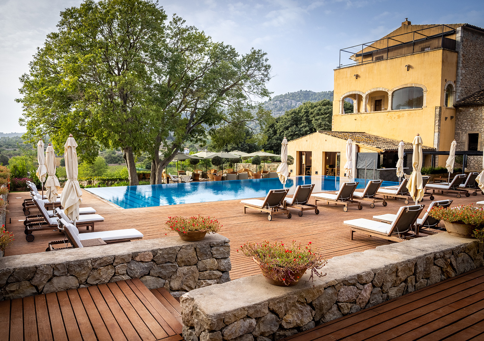 pool and lounge chairs outside of hotel