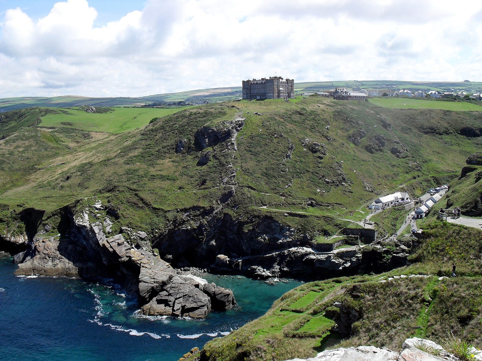 Grassy hill with a large building at the peak of the hill