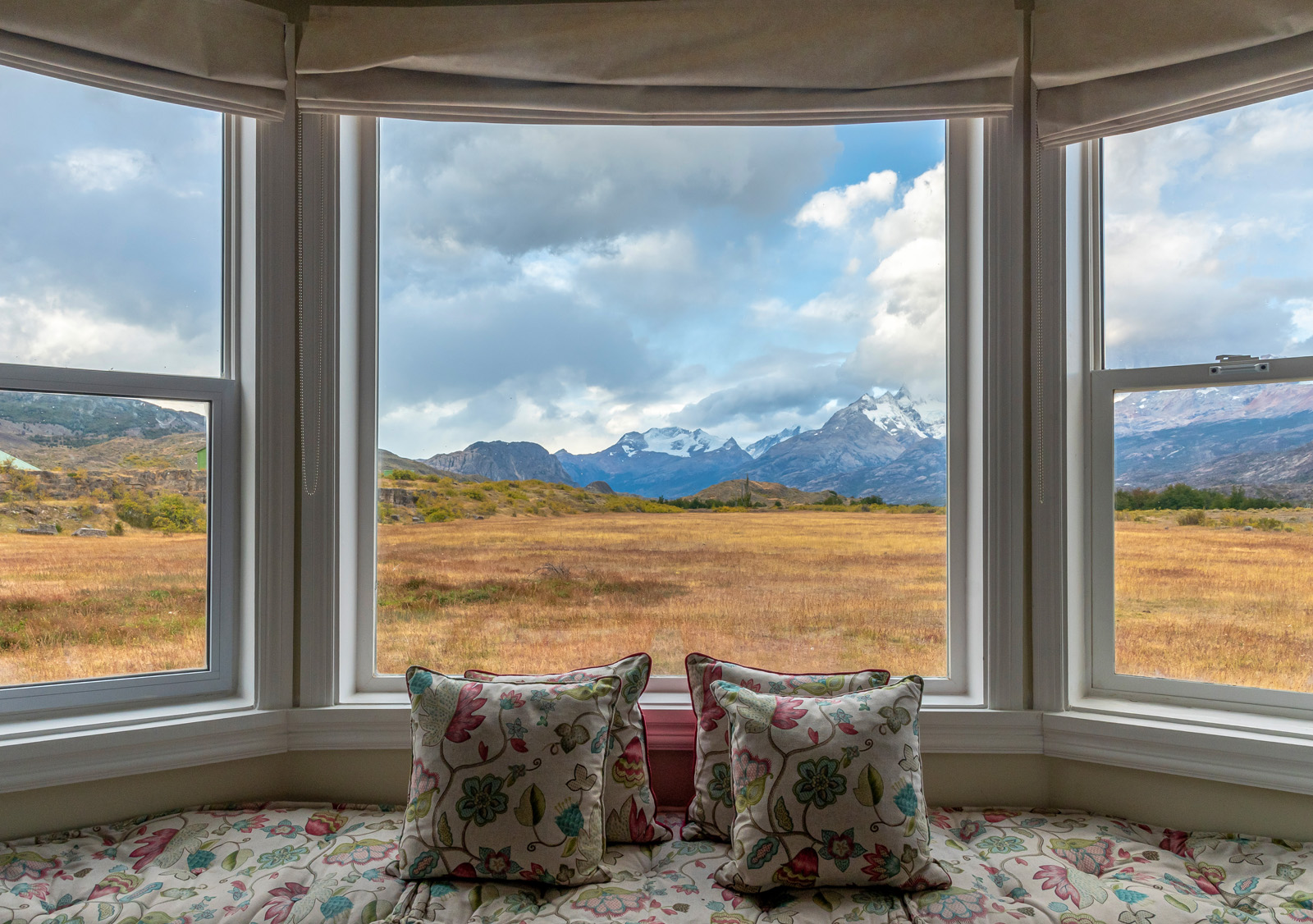 large bay windows looking onto mountains