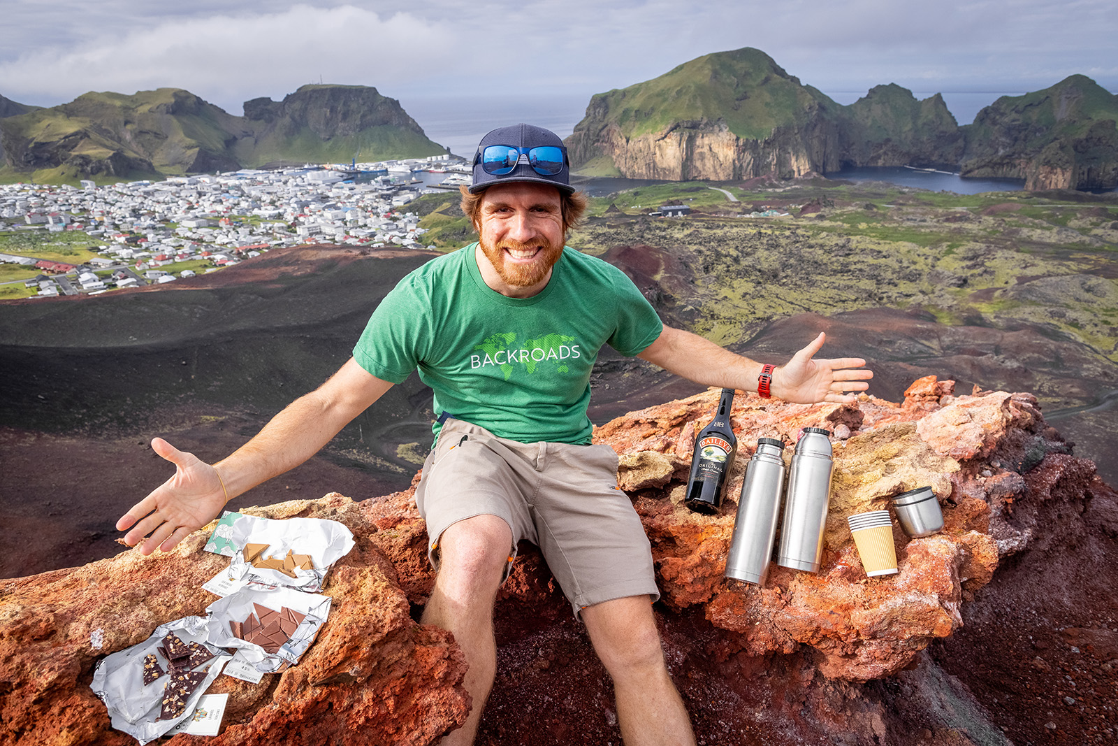 Man with snacks and bottles with his arms wide open