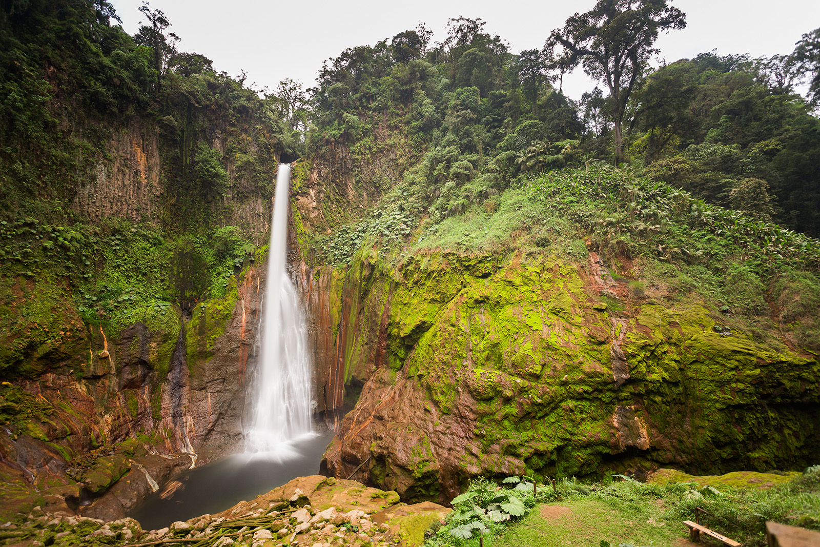 Large cliff with a waterfall flowing through the left