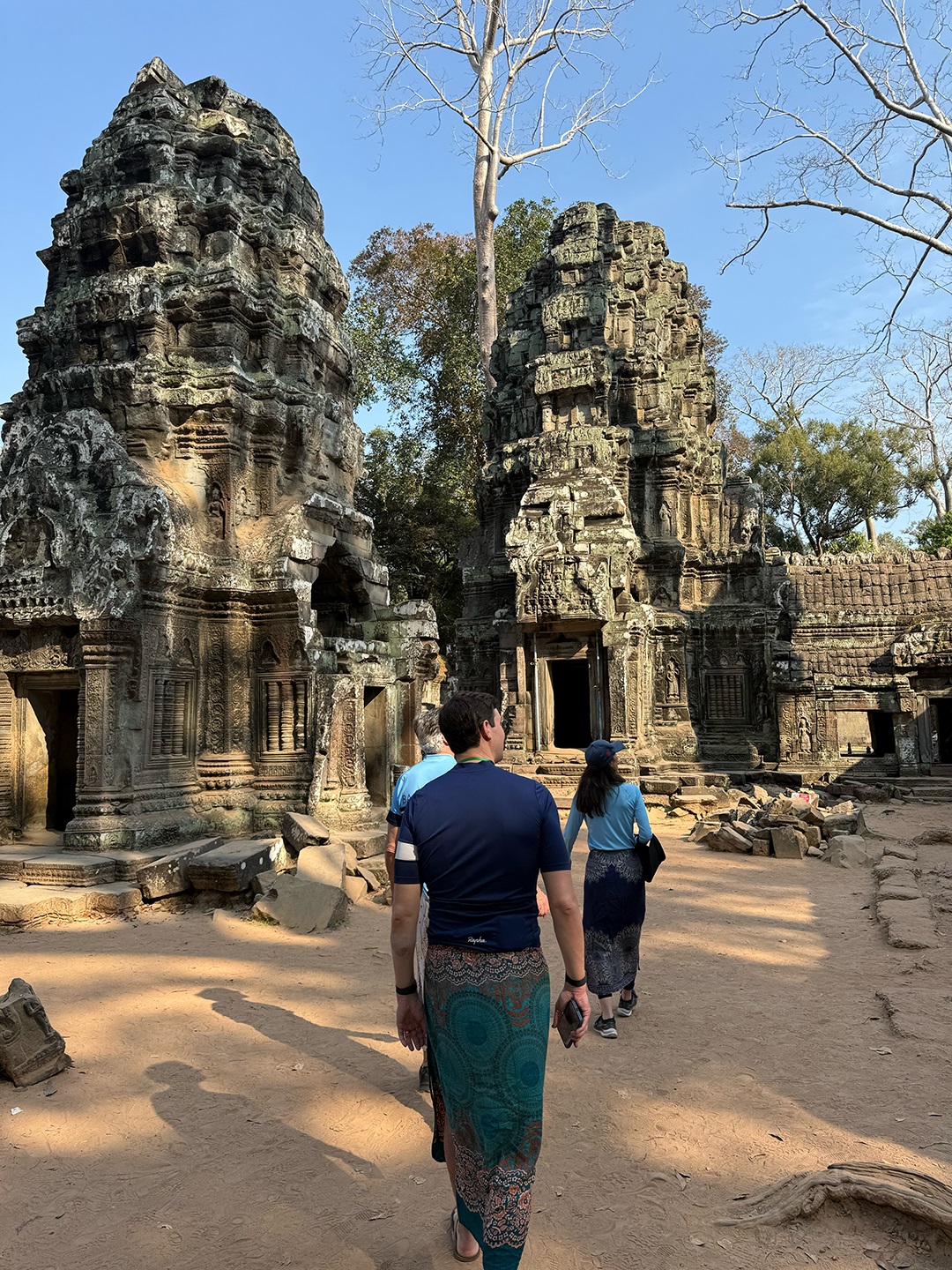 Man walking through sandy, ancient ruins