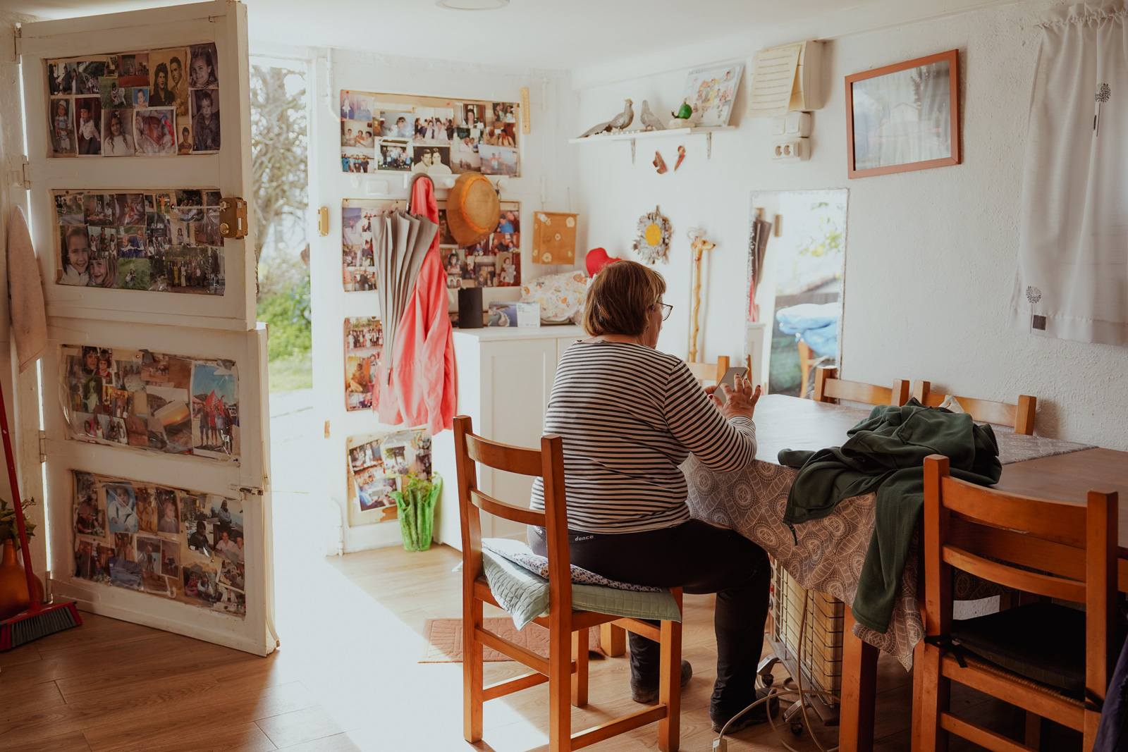 Woman sitting on a chair in a room with photos hanging on the walls