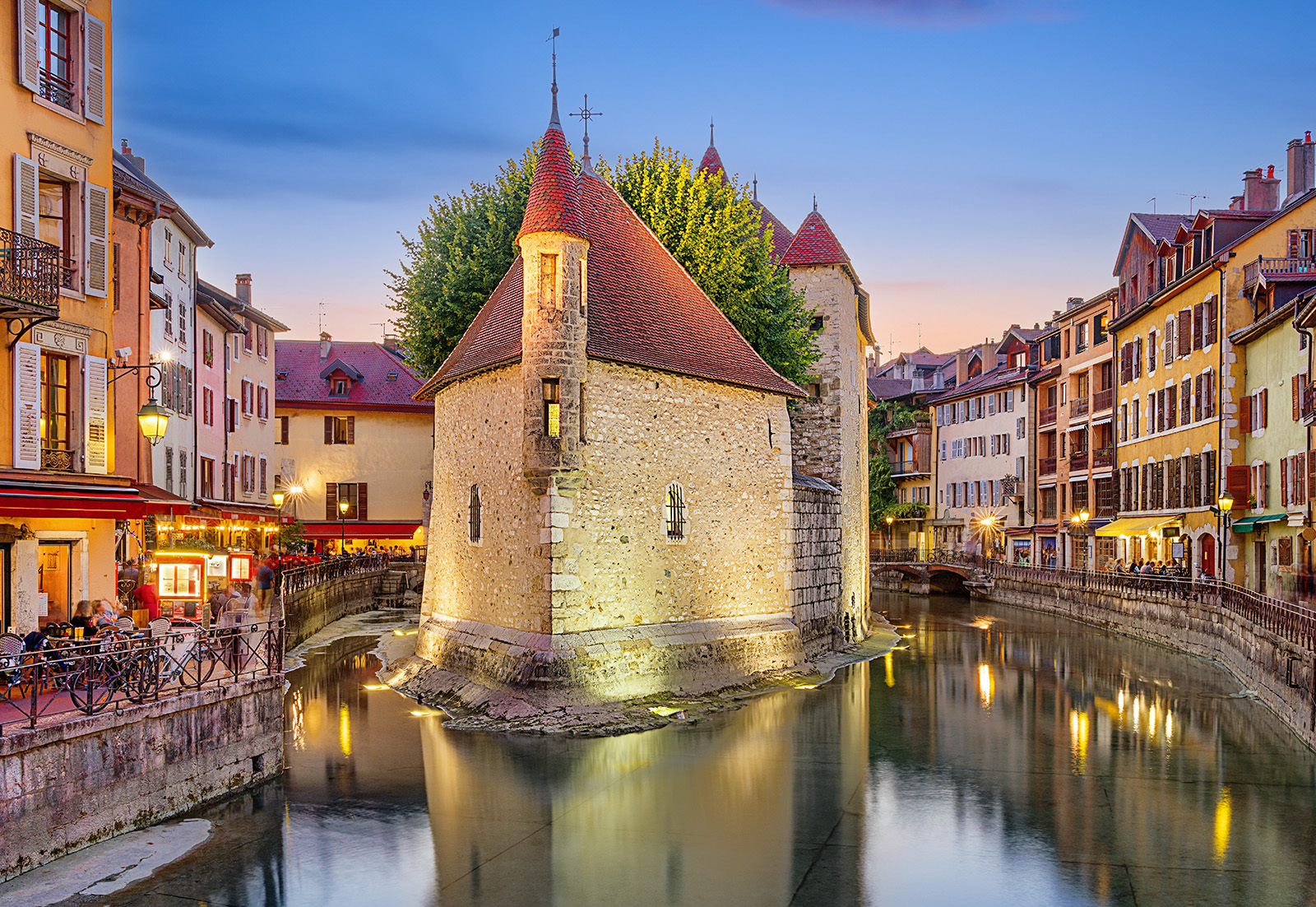 Stone buildings surrounded by small rivers in a town center
