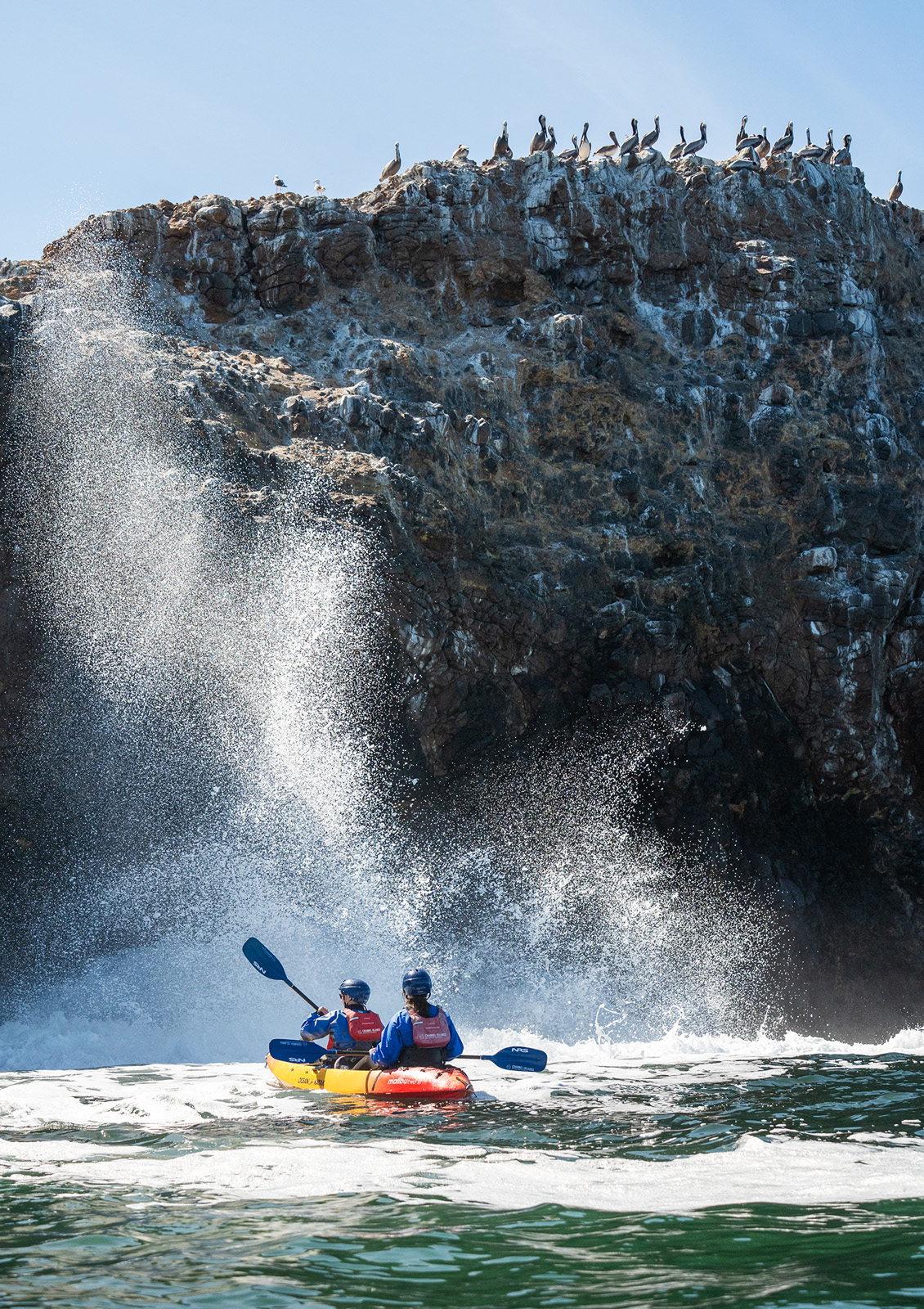 Two people on a kayak paddling on a lake