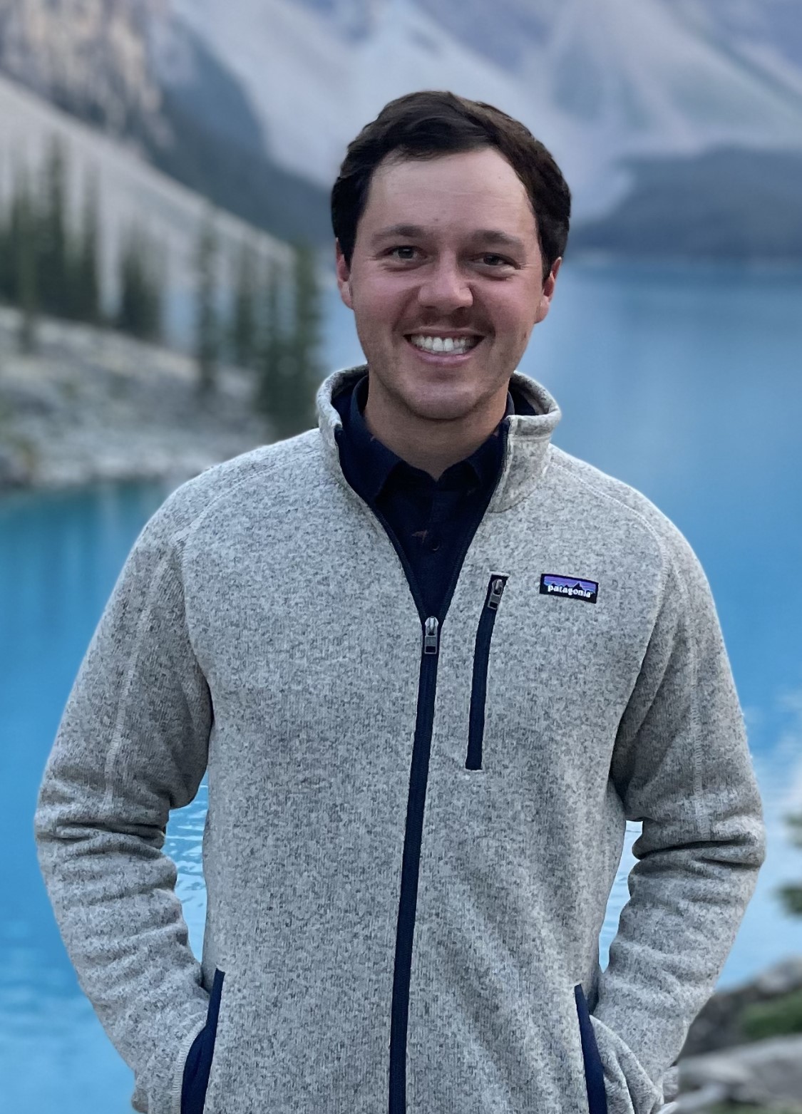 Man smiling with a large lake in the background