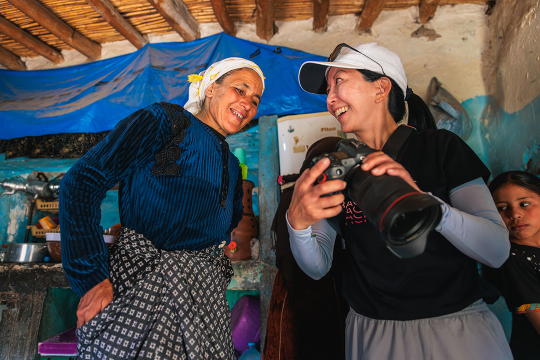 Woman showing another woman a photo on a camera