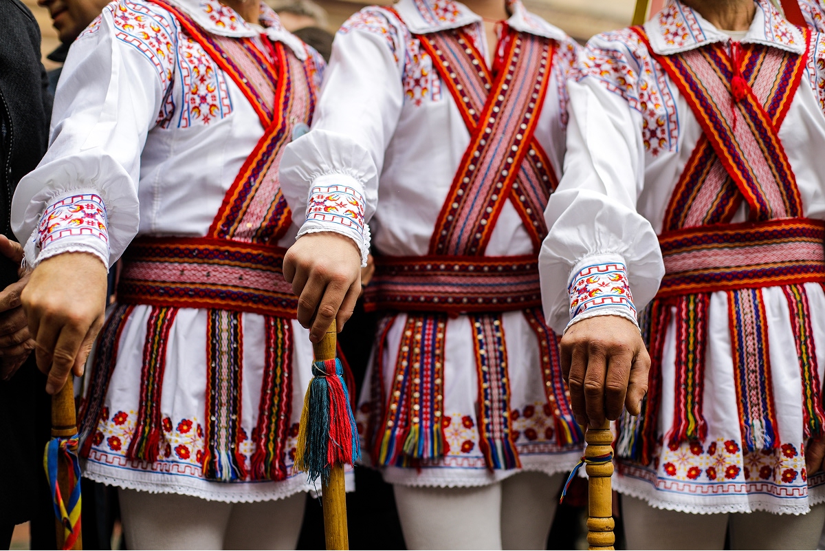 Three people wearing traditional, European attire