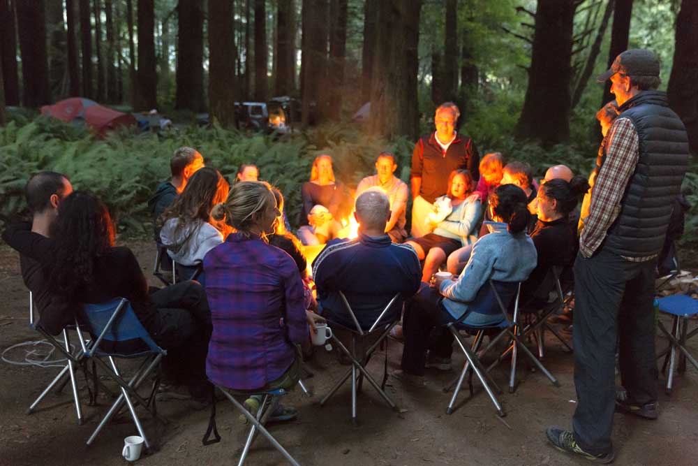Friends and Family gathered around a Backroads campfire