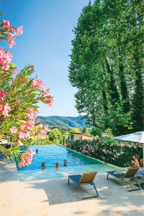 Family in pool with mountains in background