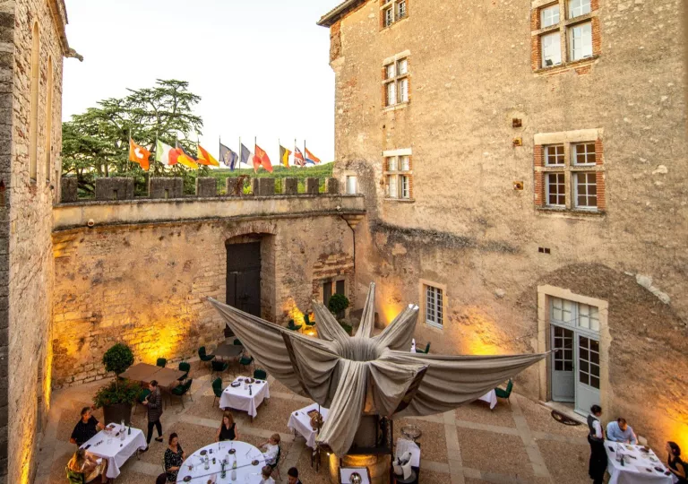stone outdoor dining area with people eating