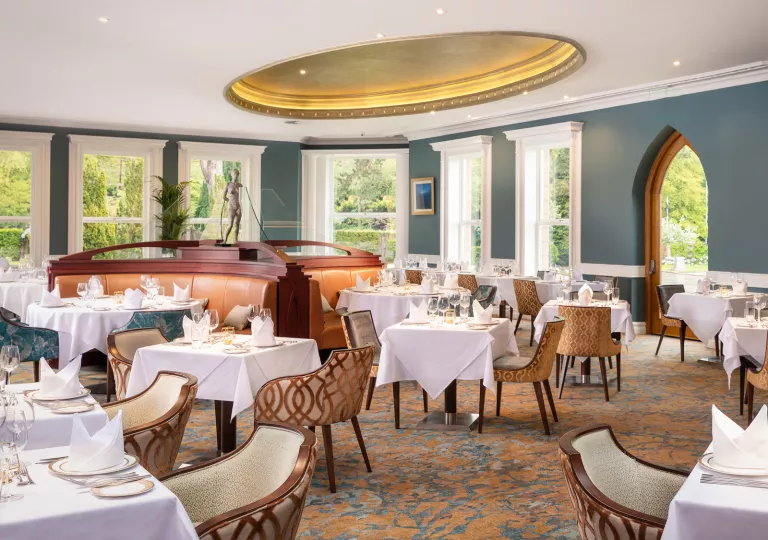 Indoor dining area with white table cloths on all dining tables