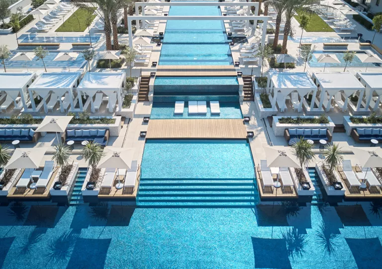 large swimming pool with decks and lounge chairs throughout