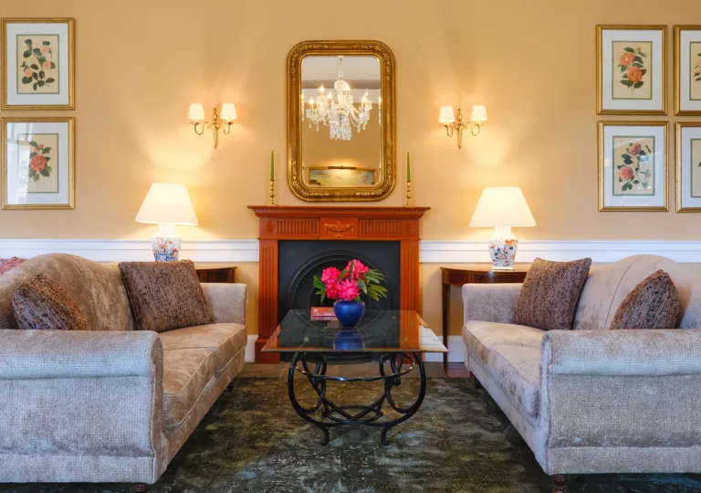Two couches in a hotel lobby with a glass table in between them