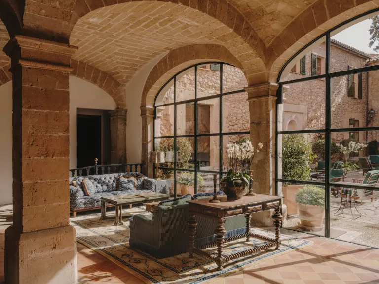 Indoor lobby with couches with a view of an outdoor patio