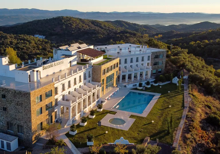 Large top-view shot of a hotel with outdoor pool