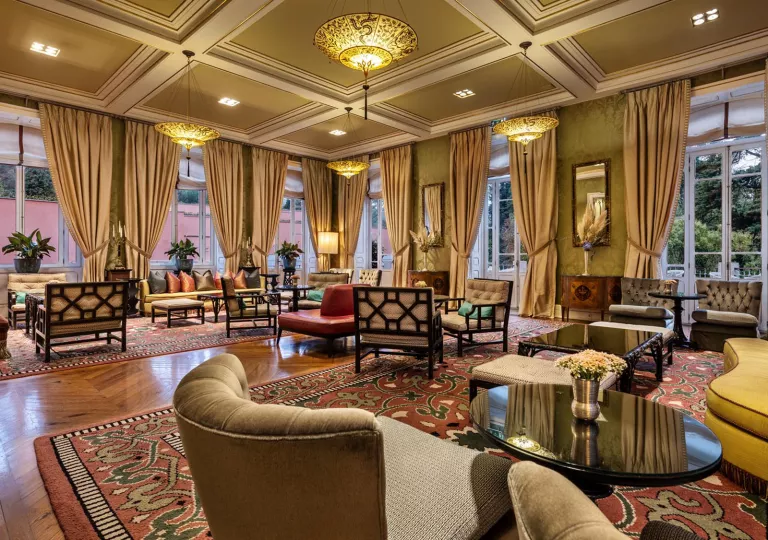 Lobby with large, tan curtains and cushioned chairs throughout the room