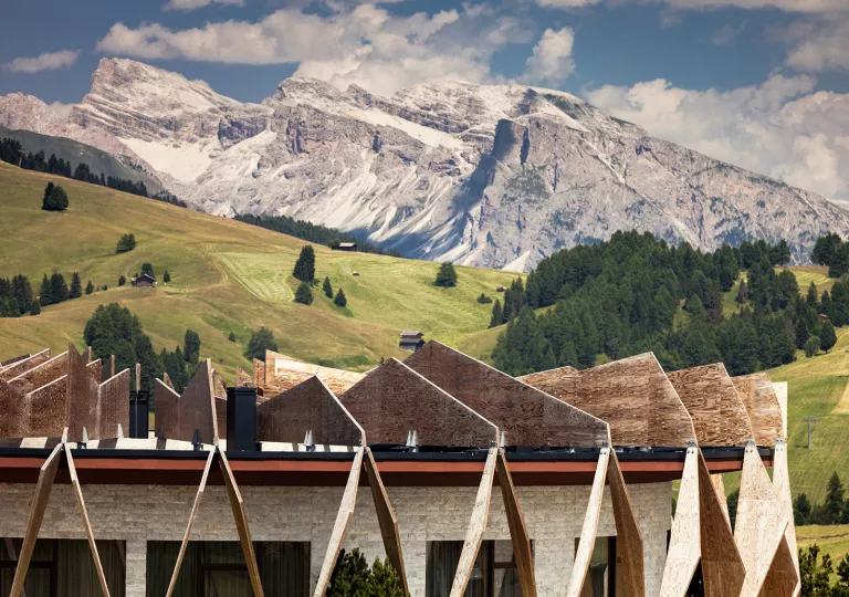 Dolomites Hotel Exterior with Mountain Backdrop