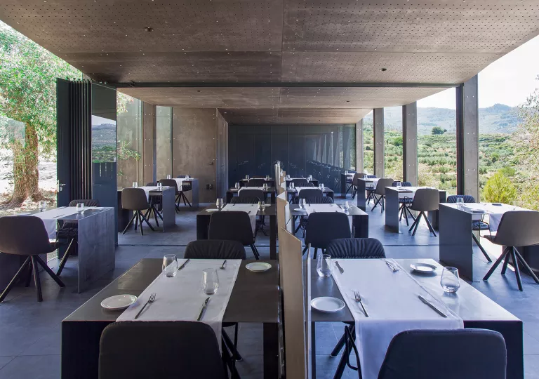 tables in a hotel restaurant with glass walls