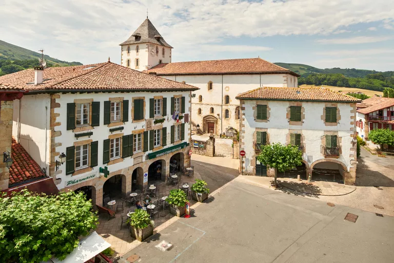 Town square with surrounding restaurants and tables