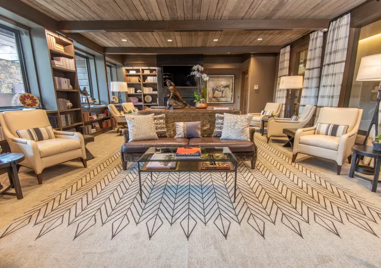living room with wood paneling and large carpet