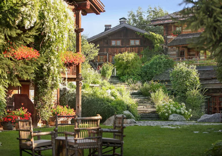 Outdoor garden and grass area with a wooden lodge in the background