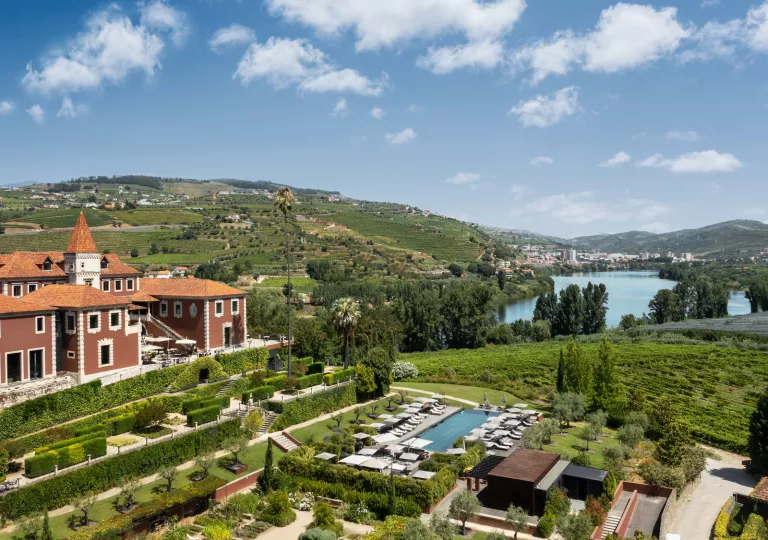 Top view of red building with a garden and outdoor pool in front