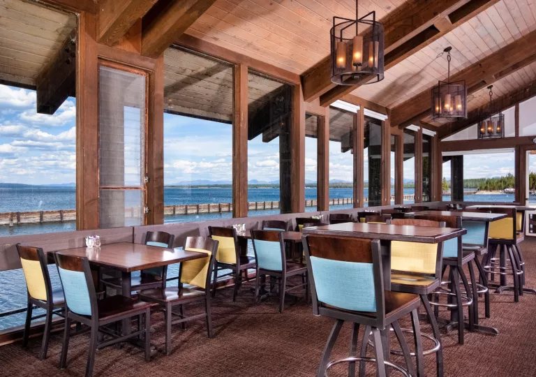 Restaurant dining area with large windows looking out towards the ocean