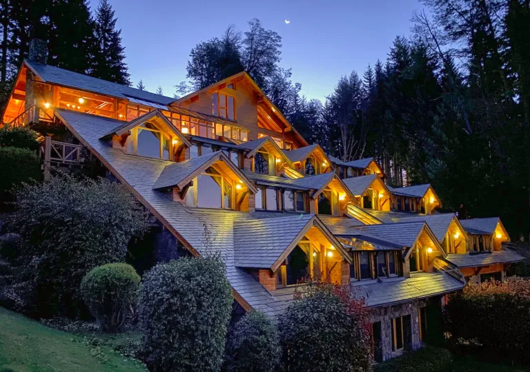 Exterior view of a multi-story building with warm lights in the evening