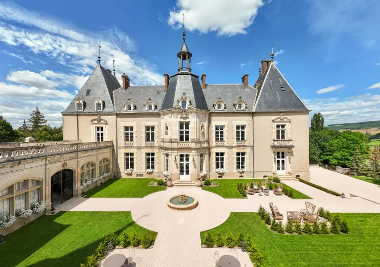 Exterior view of castle-like building with a courtyard in front