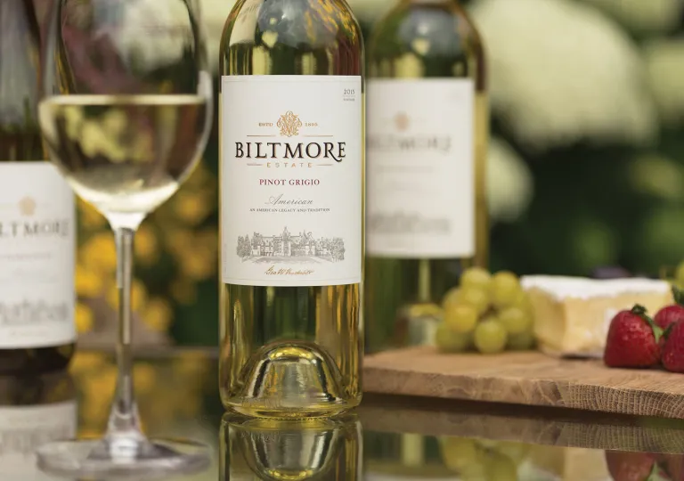 Bottles of wine with a half full wine glass