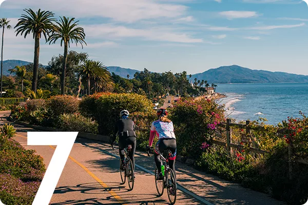 text:7; image: Bikers cycling down a beach front road