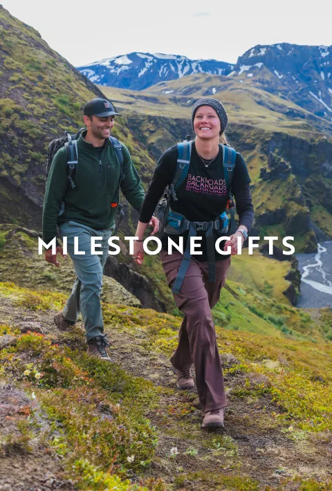 Two Backroads guests on a hike with copy overlay "milestone gifts"