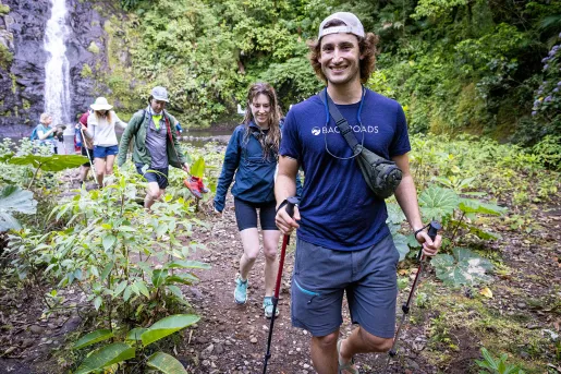 Leader Hiking Group Away From Waterfall