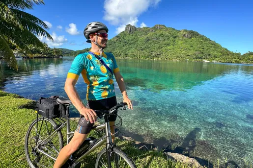 Riding a bike next to a bay in Tahiti