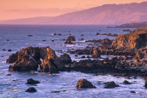 Sunset shot of rocky California coastline.