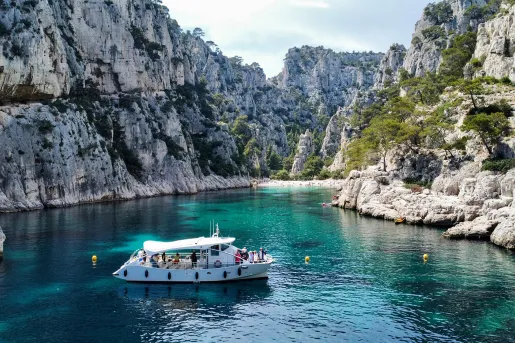 Boat on Water Surrounded by Rocks