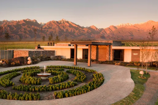entrance to hotel with mountains in backdrop