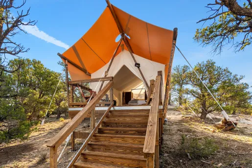 Tent with wooden steps leading the the porch