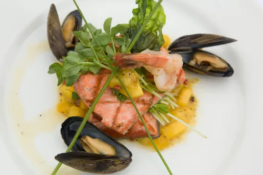 Plate of seafood consisting of salmon, shrimp and mussels