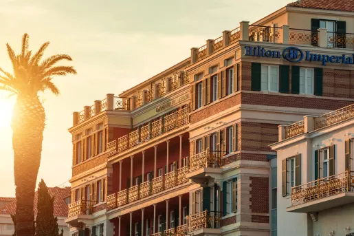 hotel at sunset with a palm tree