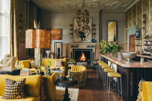 Indoor lounge with a fireplace and bar on the right