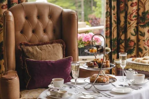 Leather couch with a white table full of pastries and tea