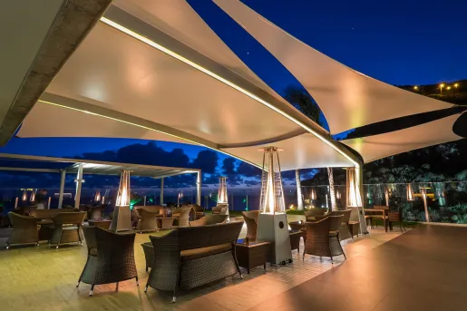 Outdoor lounge with heaters and a tent covering the sky