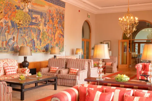 Red and white cushioned chairs in a hotel lobby