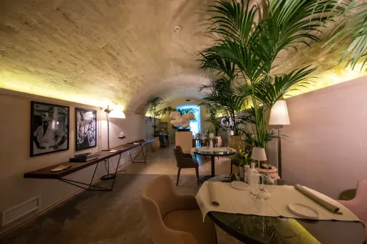 Hallway with dining tables and portraits on the walls