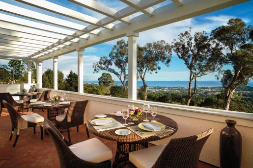 Outdoor dining patio with woven chairs and tables