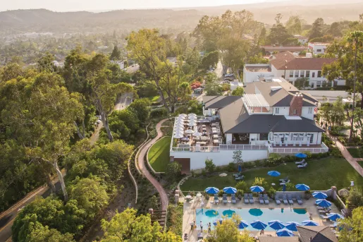 Top view of hotel with outdoor patio and an outdoor pool